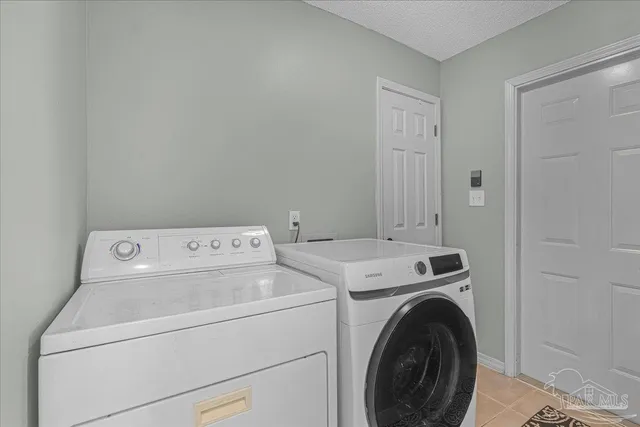 a view of storage and utility room with washer and dryer