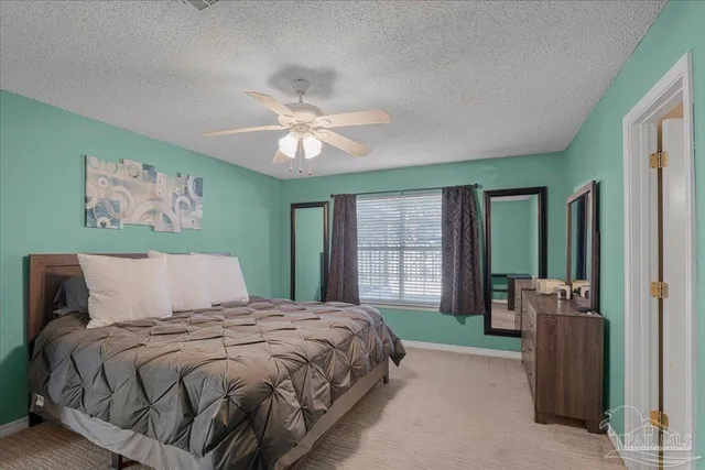 a bedroom with a large bed and a window