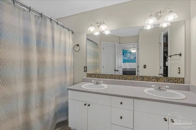 a bathroom with a double vanity sink and a mirror