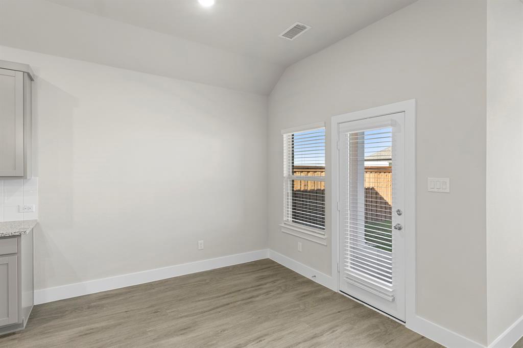 2372 Bell Way Forney, TX 75126 - Photo 18 of 39 an empty room with wooden floor and windows
