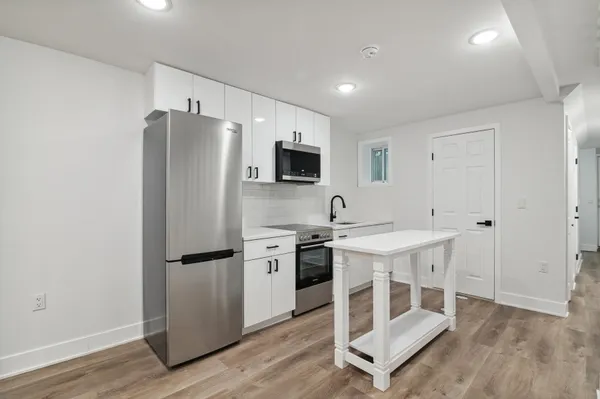 a kitchen with stainless steel appliances a refrigerator and a stove top oven