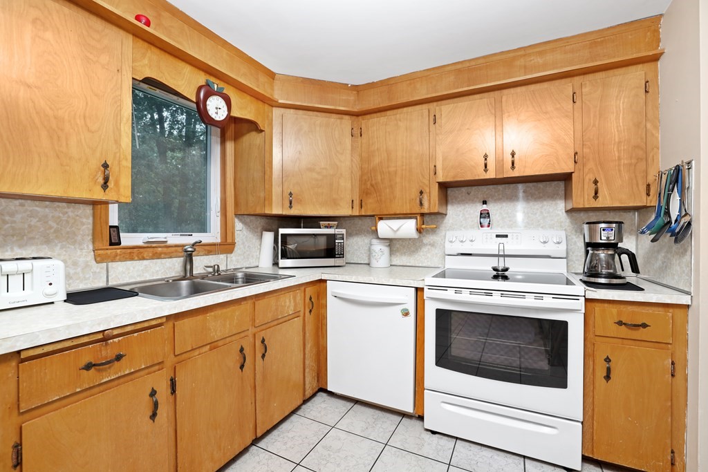 6 Roach Road Stoughton, MA 02072 - Photo 7 of 26 a kitchen with a stove sink and cabinets