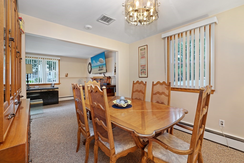6 Roach Road Stoughton, MA 02072 - Photo 10 of 26 a view of a dining room with furniture and a chandelier