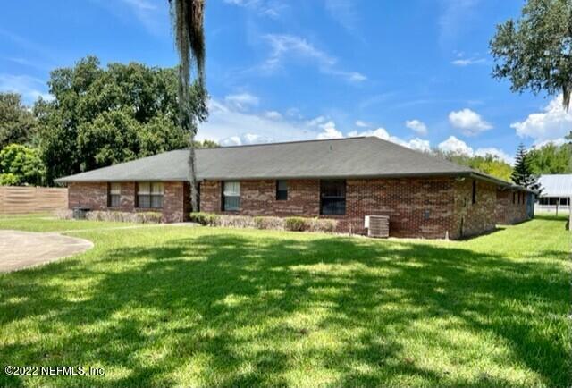 11643 Olde Mandarin Road Jacksonville, FL 32223 - Photo 1 of 70 a front view of a house with a garden