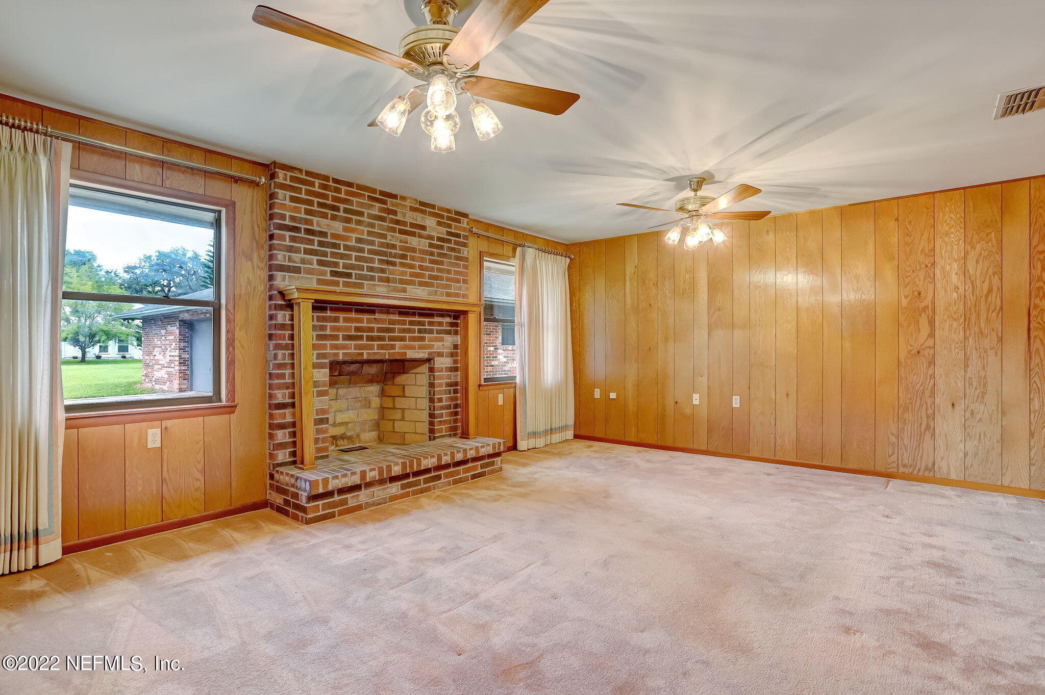 11643 Olde Mandarin Road Jacksonville, FL 32223 - Photo 26 of 70 an empty room with windows chandelier fan and windows