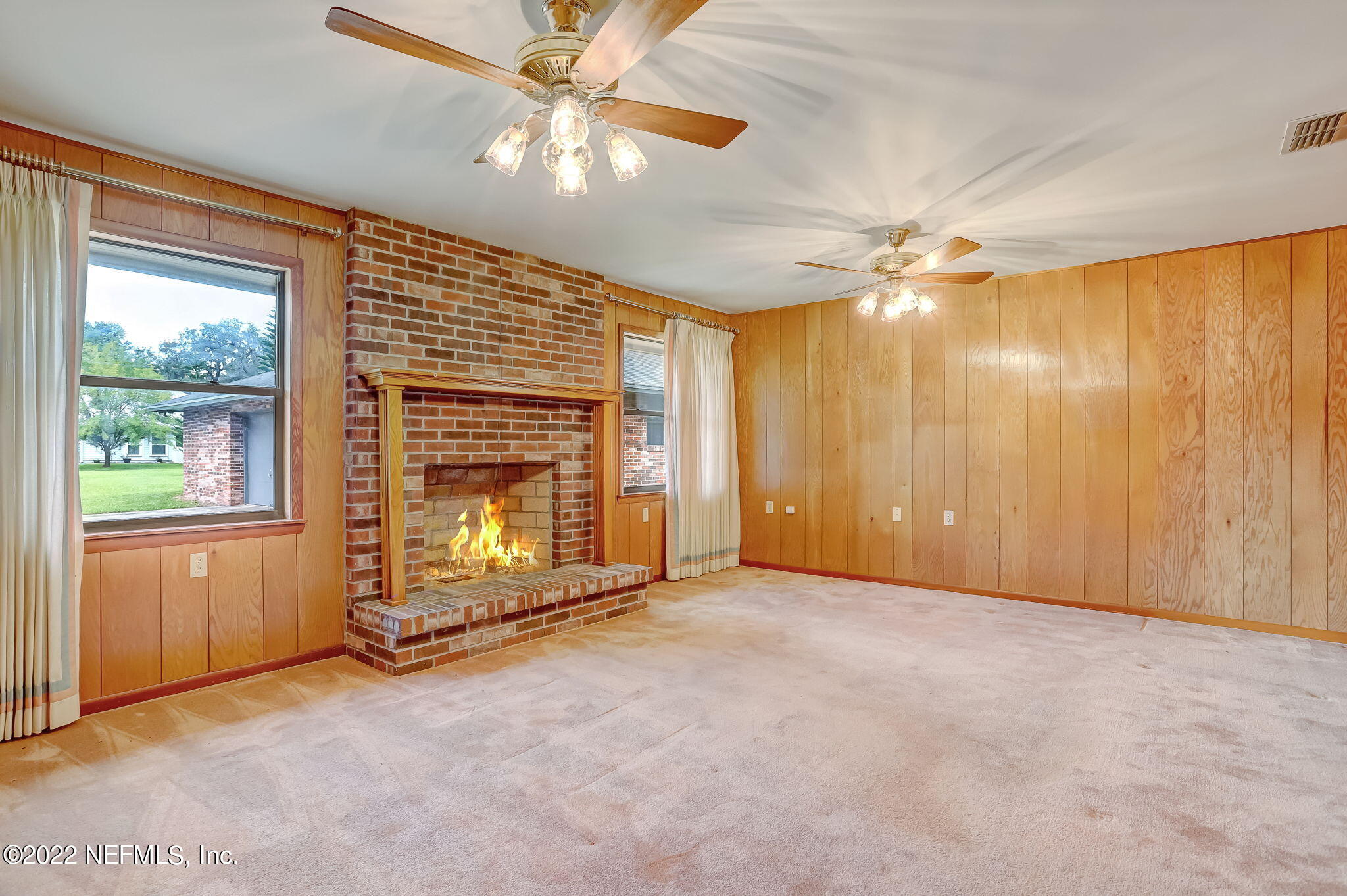 11643 Olde Mandarin Road Jacksonville, FL 32223 - Photo 27 of 70 an empty room with windows chandelier fan and windows