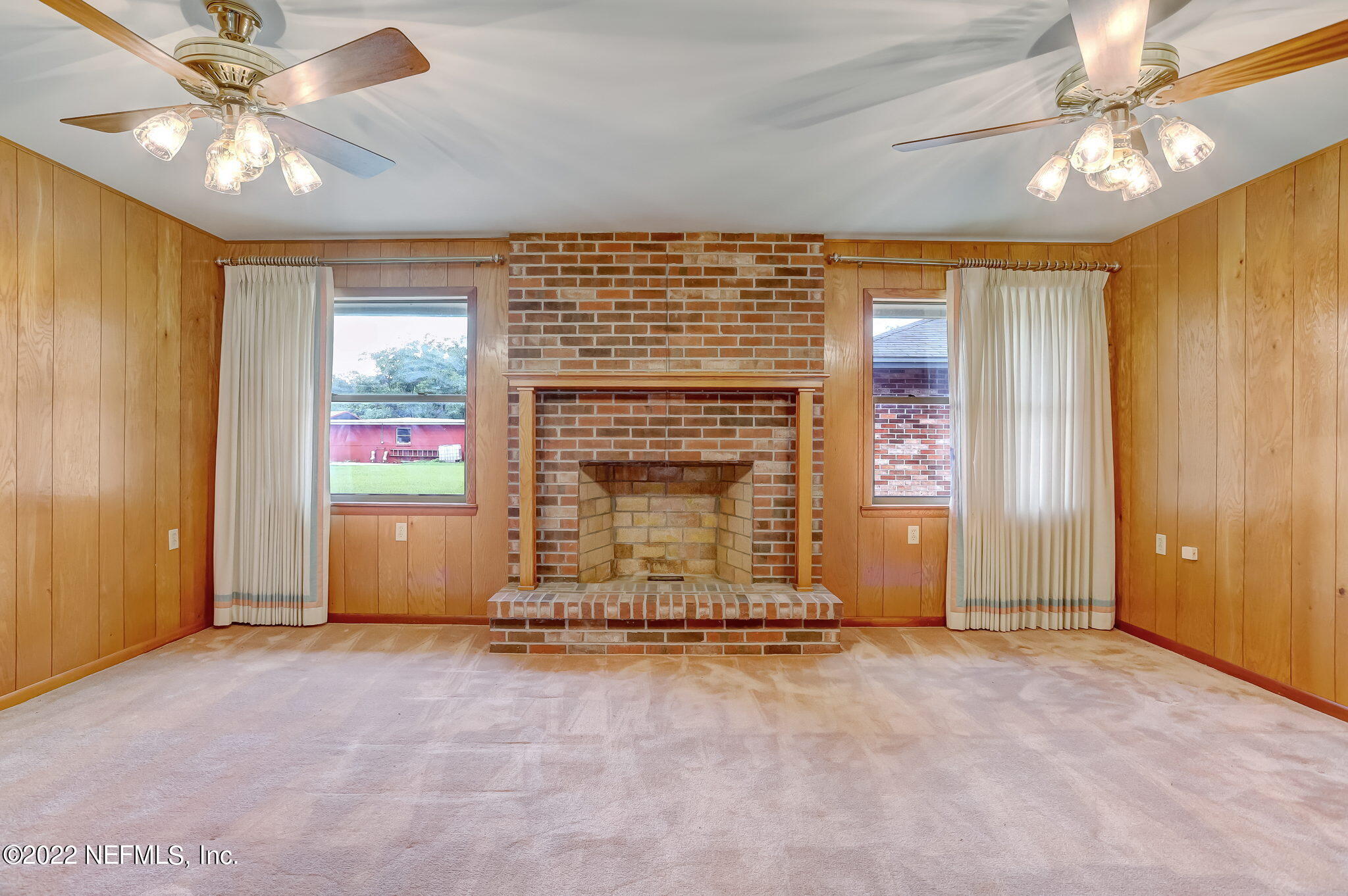 11643 Olde Mandarin Road Jacksonville, FL 32223 - Photo 28 of 70 an empty room with windows chandelier fan and fire place