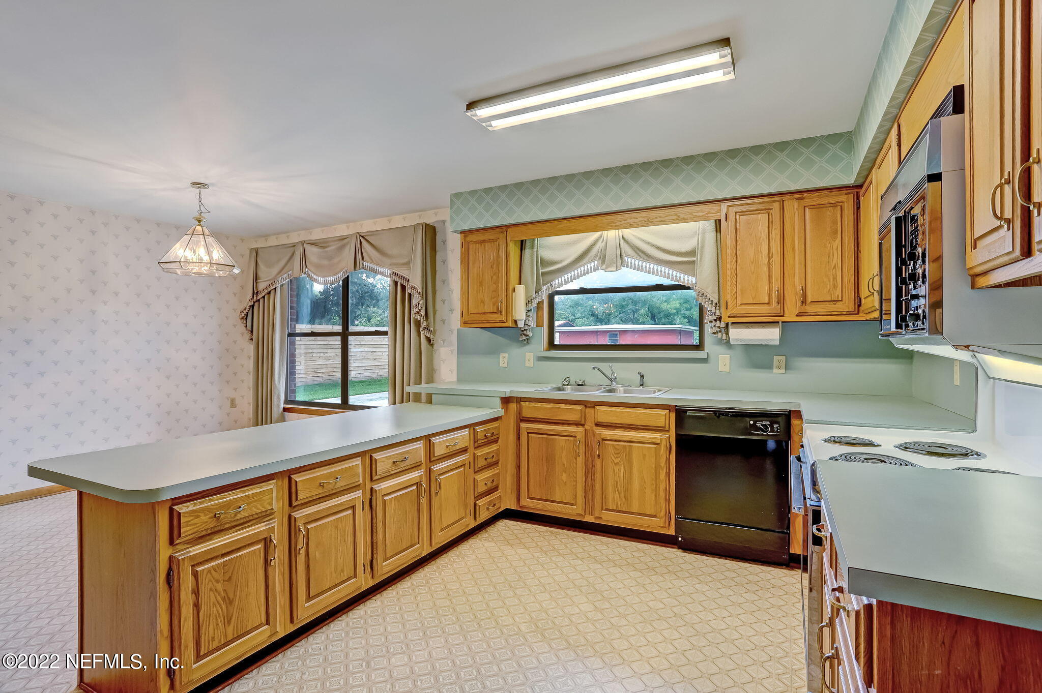 11643 Olde Mandarin Road Jacksonville, FL 32223 - Photo 30 of 70 a kitchen with stainless steel appliances granite countertop a sink and a stove
