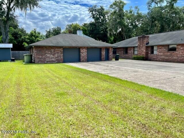 11643 Olde Mandarin Road Jacksonville, FL 32223 - Photo 3 of 70 a front view of a house with a yard and a garage