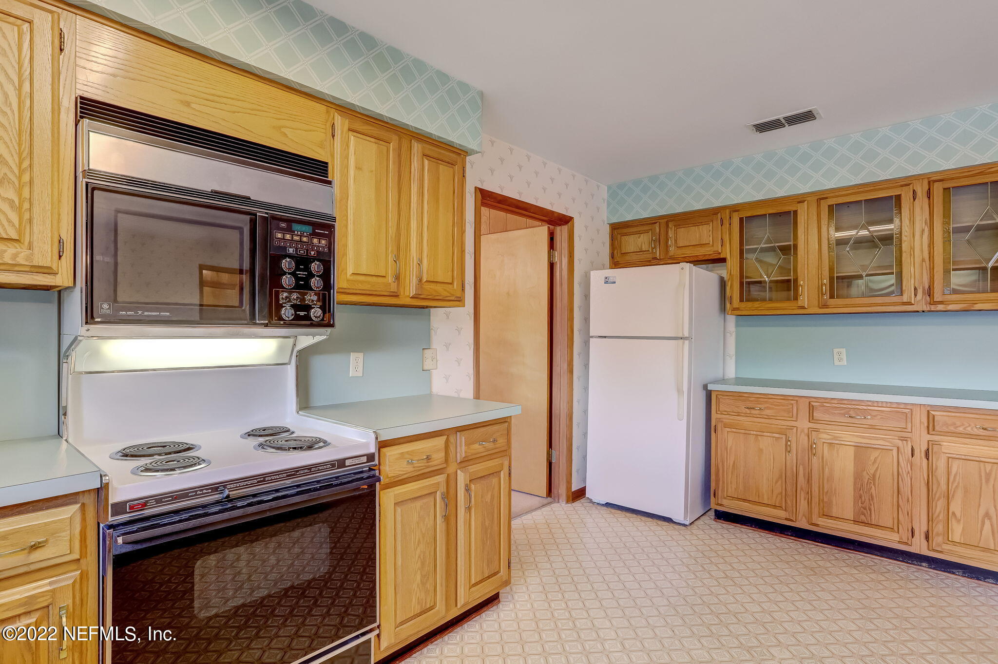 11643 Olde Mandarin Road Jacksonville, FL 32223 - Photo 33 of 70 a kitchen with stainless steel appliances granite countertop a stove a refrigerator and a microwave