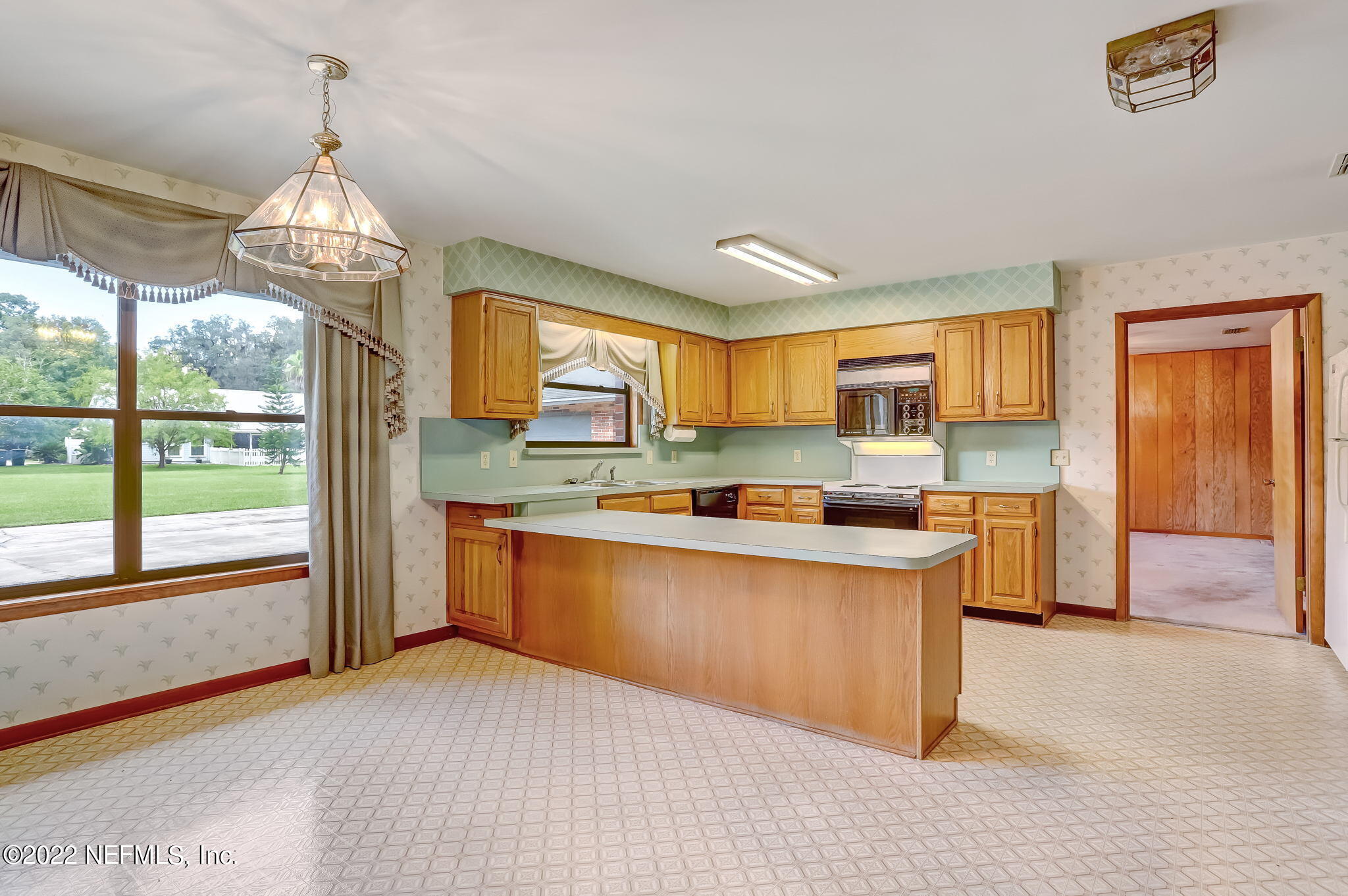 11643 Olde Mandarin Road Jacksonville, FL 32223 - Photo 36 of 70 a kitchen with stainless steel appliances granite countertop a stove and a large window