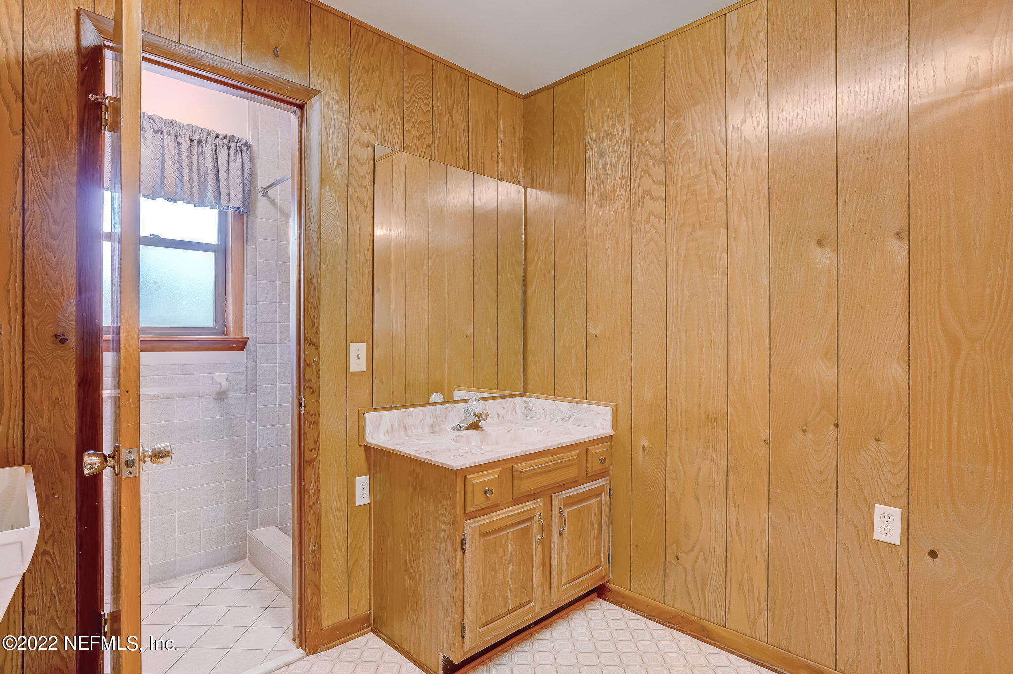 11643 Olde Mandarin Road Jacksonville, FL 32223 - Photo 38 of 70 a bathroom with a sink a mirror and a shower