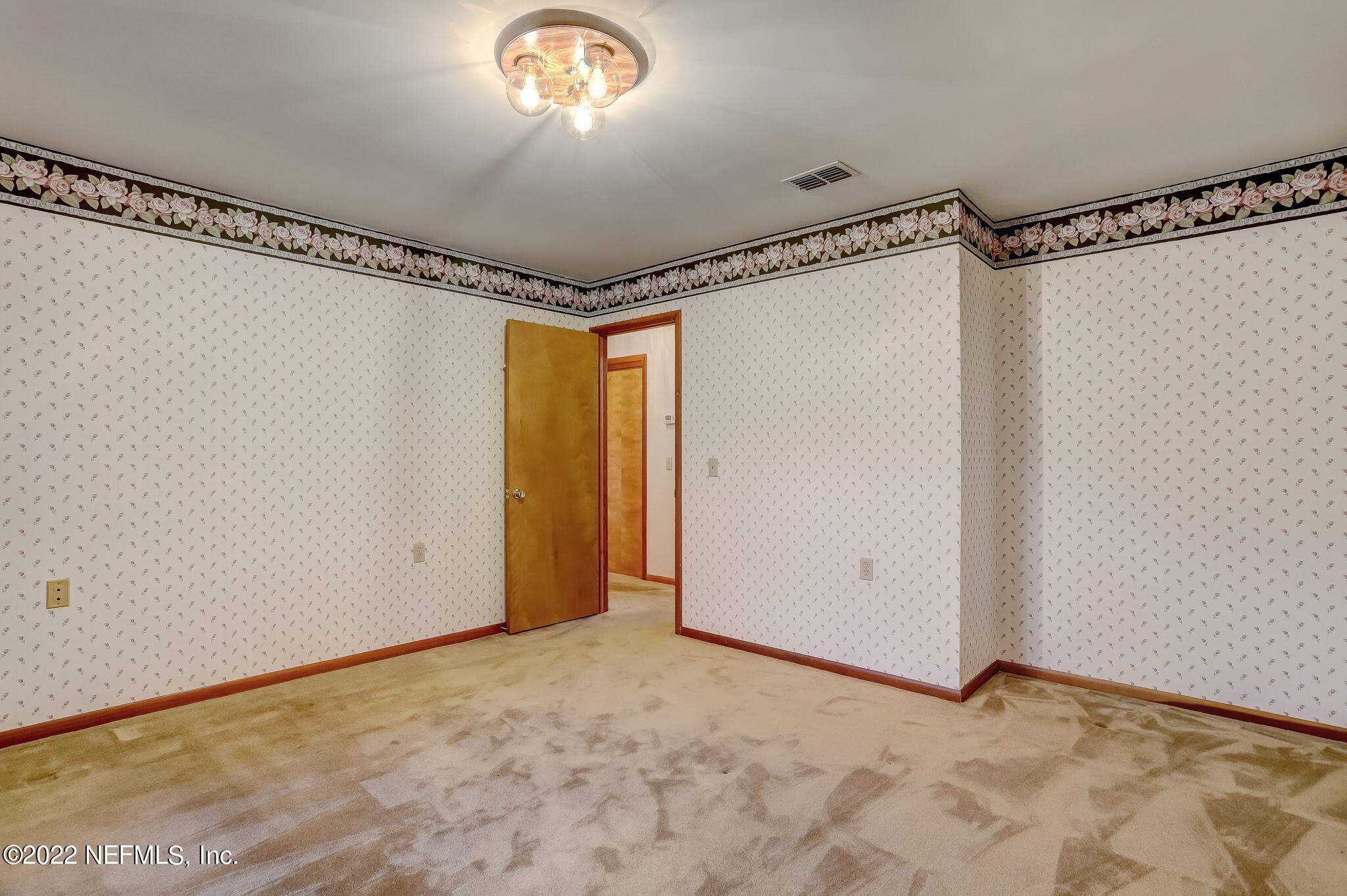 11643 Olde Mandarin Road Jacksonville, FL 32223 - Photo 51 of 70 a view of a room with a hanging light and a window