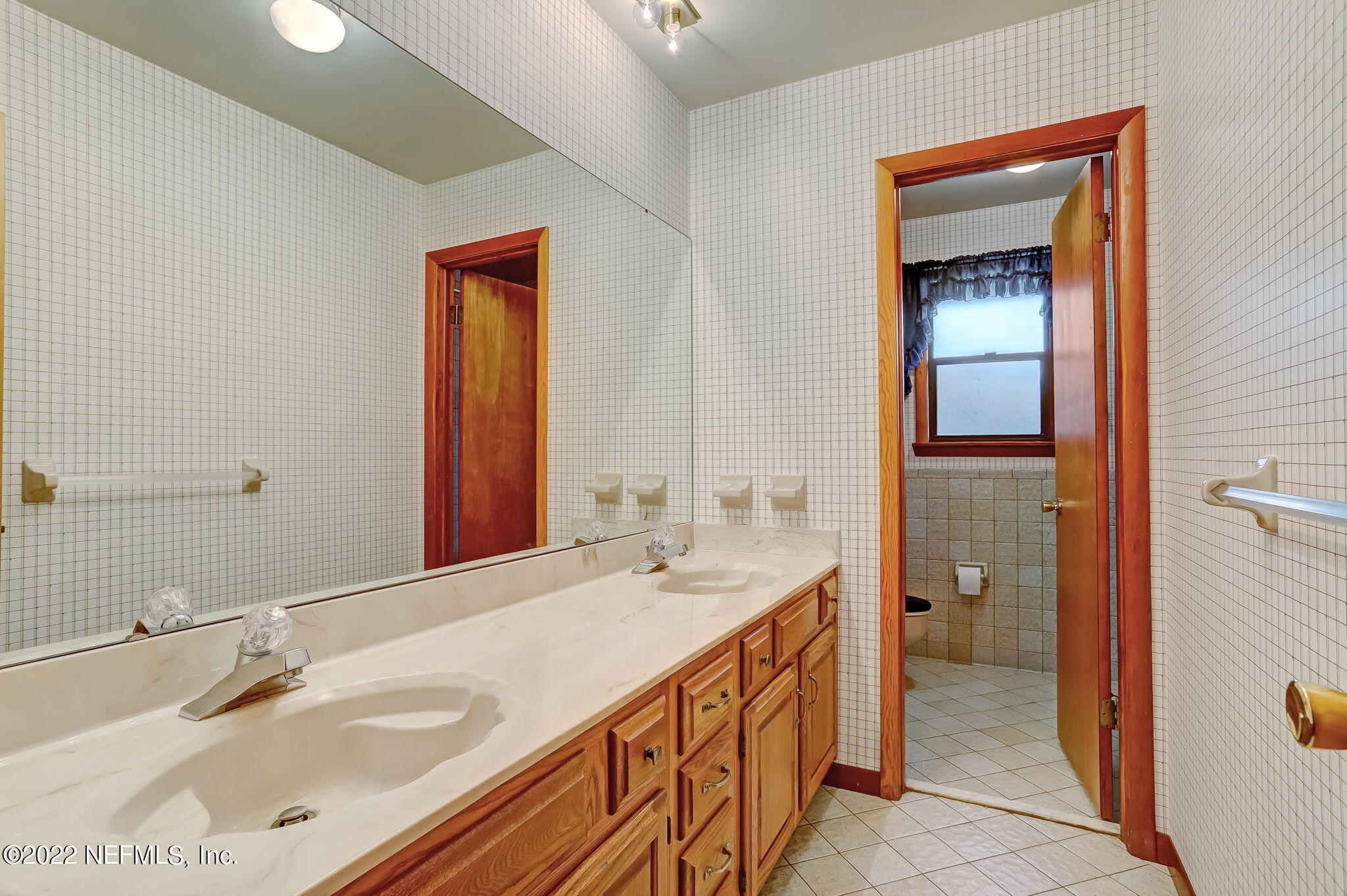 11643 Olde Mandarin Road Jacksonville, FL 32223 - Photo 59 of 70 a bathroom with a sink and a mirror