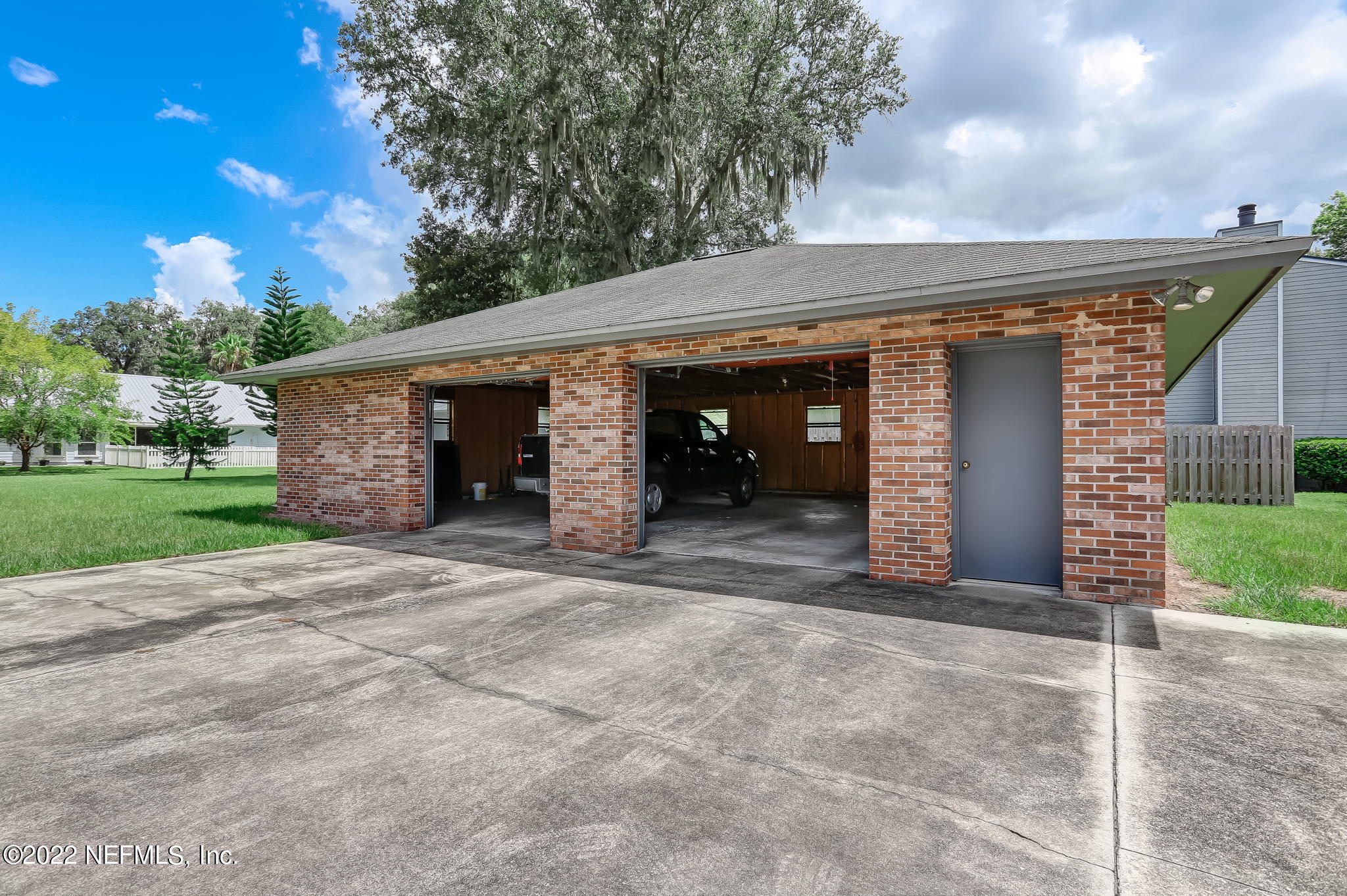 11643 Olde Mandarin Road Jacksonville, FL 32223 - Photo 66 of 70 a view of a house with a yard and garage