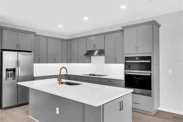 a kitchen with a sink a stove and refrigerator