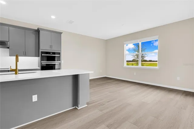 a kitchen with granite countertop a stove and a refrigerator
