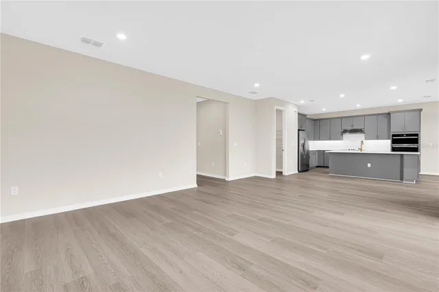 a view of kitchen with a sink and a refrigerator