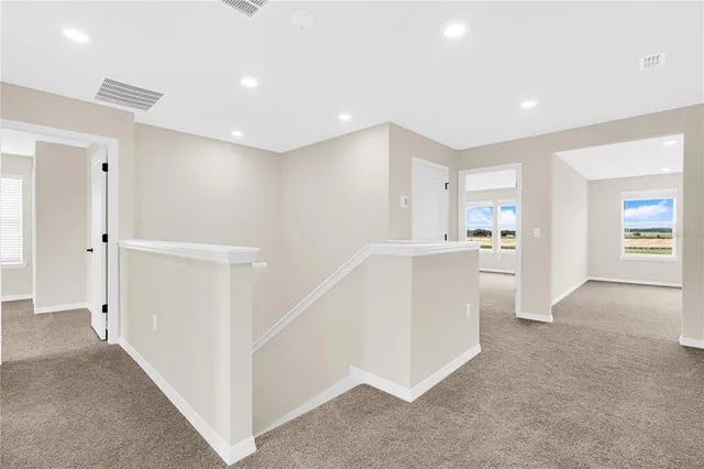 a view of a kitchen with white cabinets