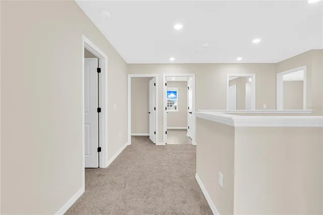 an empty room with white cabinet and mirrors