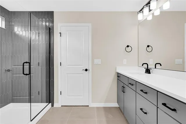 a bathroom with a double vanity sink and mirror