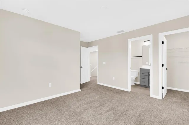 an empty room with an entrance to other room