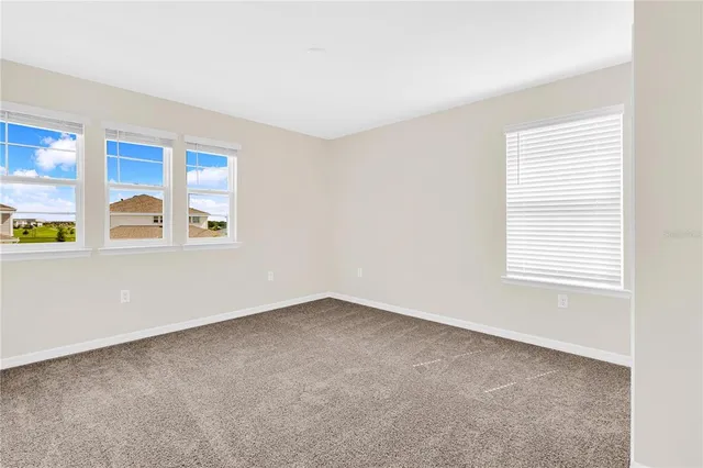 a bathroom with a granite countertop sink toilet tub mirror and vanity