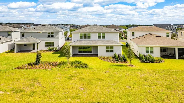 a house view with swimming pool in front of it