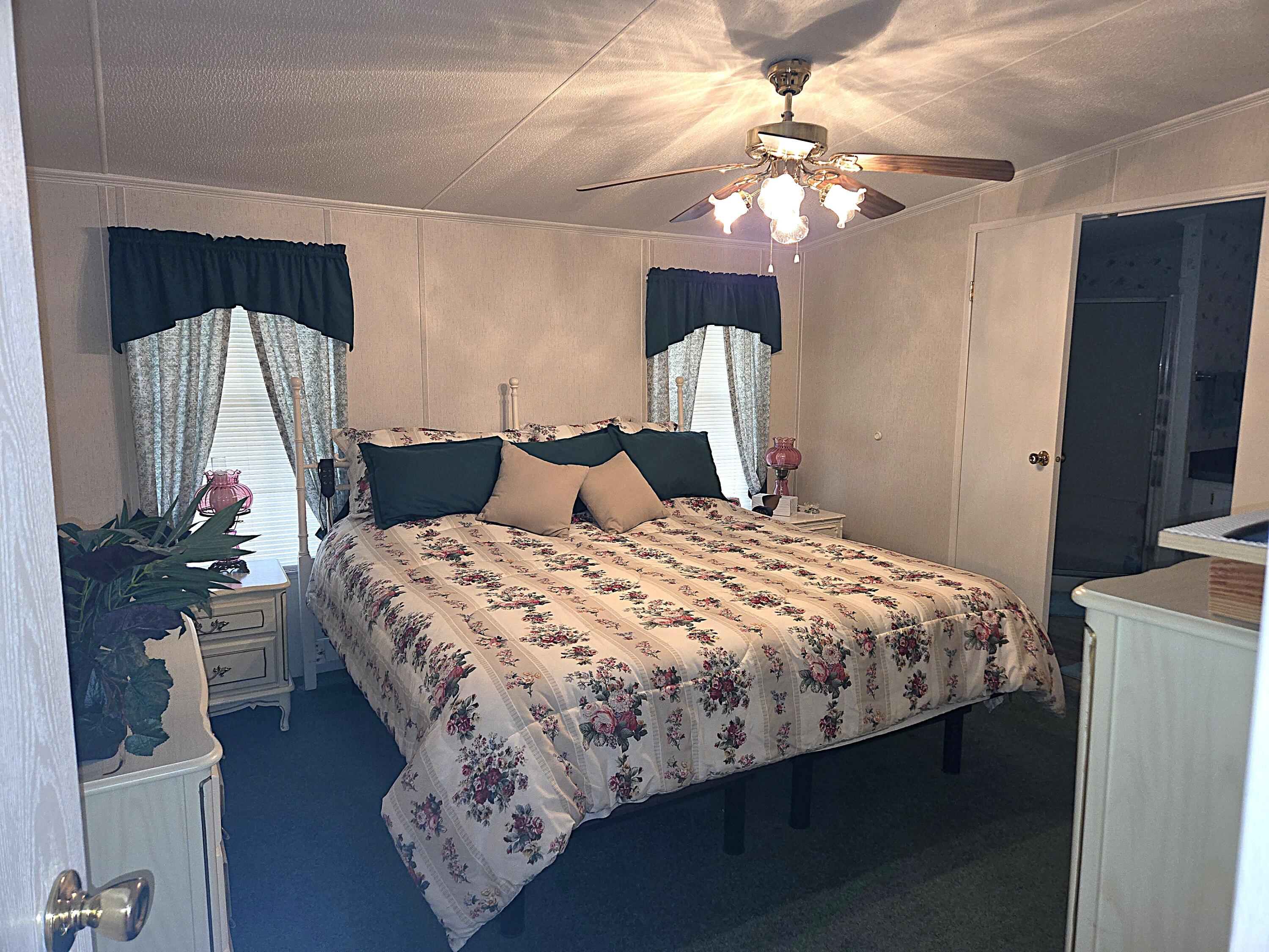 2425 Southeast 31st Street Okeechobee, FL 34974 - Photo 18 of 43 a bedroom with a bed and a chandelier