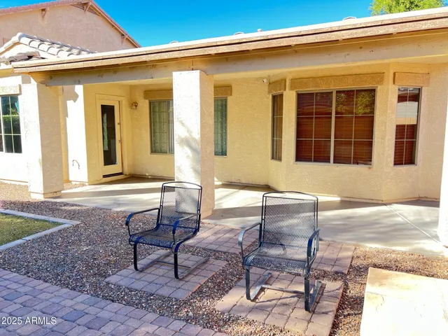 a patio with a table and chairs