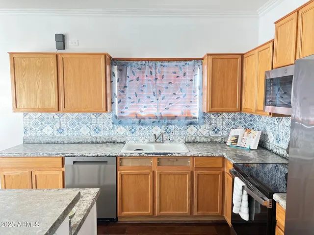 a kitchen with granite countertop a sink and a granite counter tops