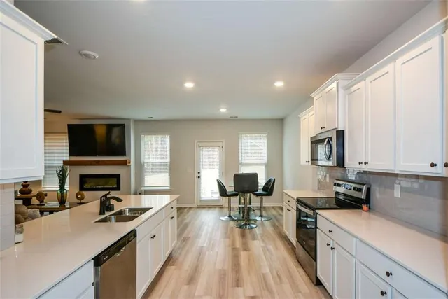 a view of a kitchen with cabinets and wooden floor