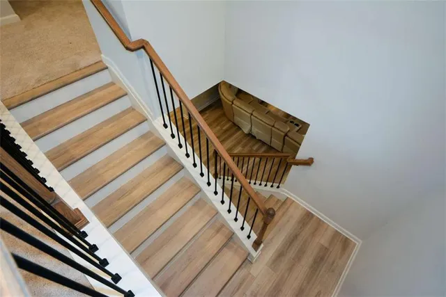 a spacious bedroom with a large bed and a chandelier