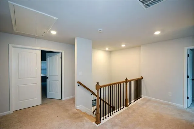 a spacious bedroom with a bed and a chandelier