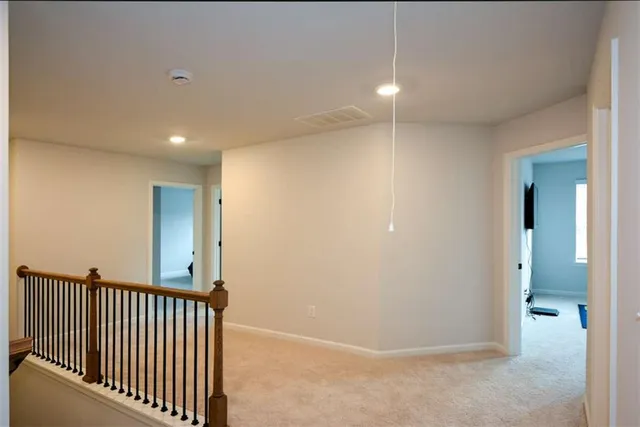 a view of an empty room and a window