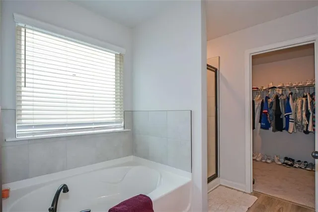 an empty room with windows and closet