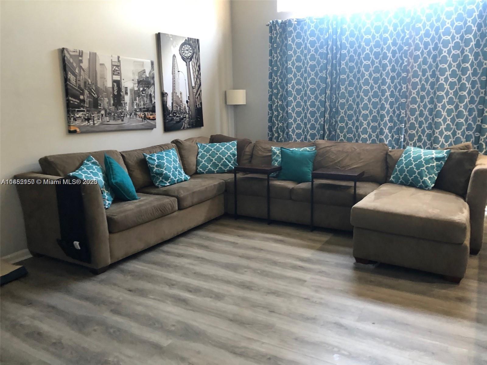 Miramar Miramar, FL 33029 - Photo 3 of 8 a living room with furniture and painting on the wall