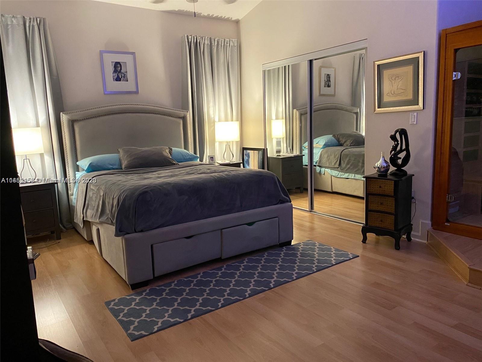 Miramar Miramar, FL 33029 - Photo 4 of 8 a bedroom with a bed and wooden floor