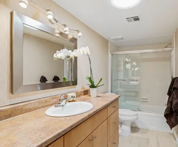 a bathroom with a toilet a sink and a mirror