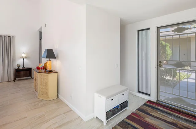 a view of a room with wooden floor and windows