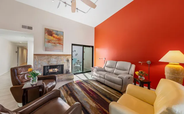 a living room with furniture and a fireplace