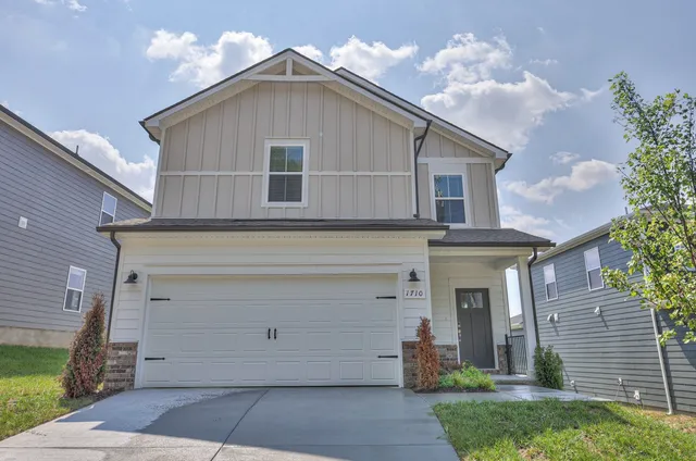 a front view of a house with garage