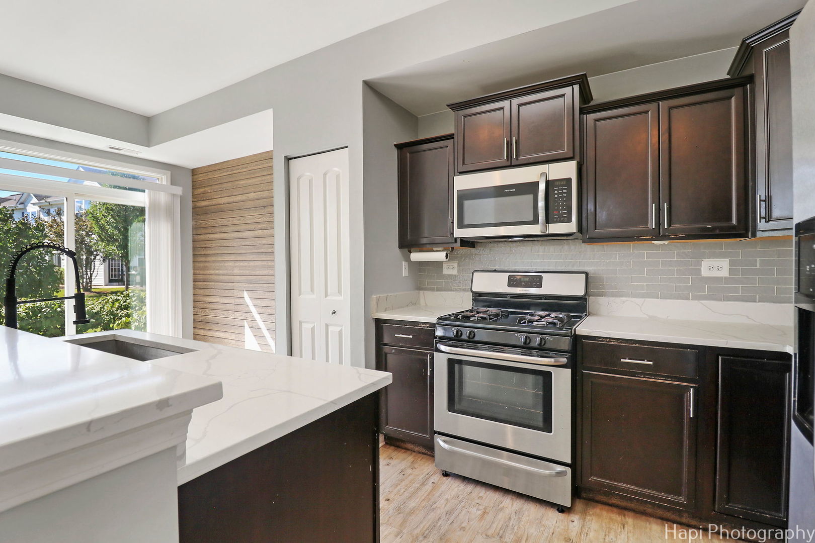 672 Anchorage Court Pingree Grove, IL 60140 - Photo 11 of 31 a kitchen with granite countertop a stove microwave and sink