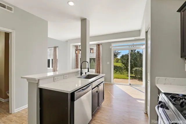 a kitchen with a sink stove and cabinets