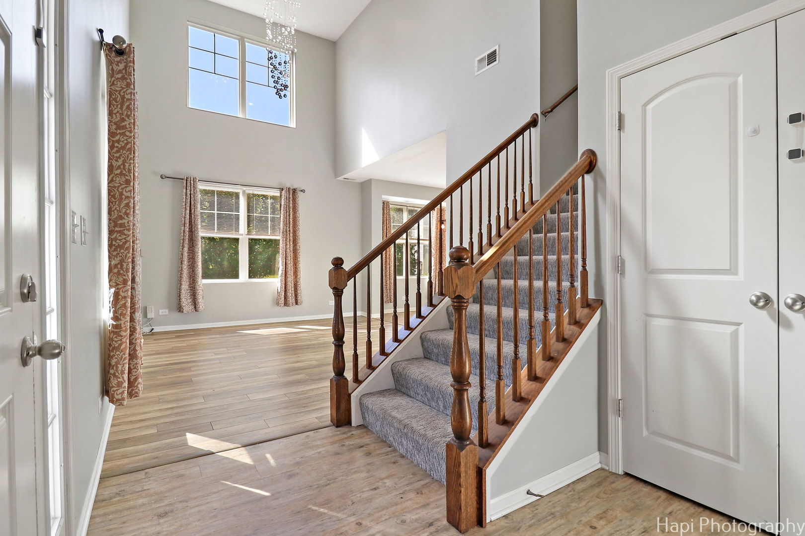 672 Anchorage Court Pingree Grove, IL 60140 - Photo 3 of 31 a view of staircase with lots of frames on wall and a window