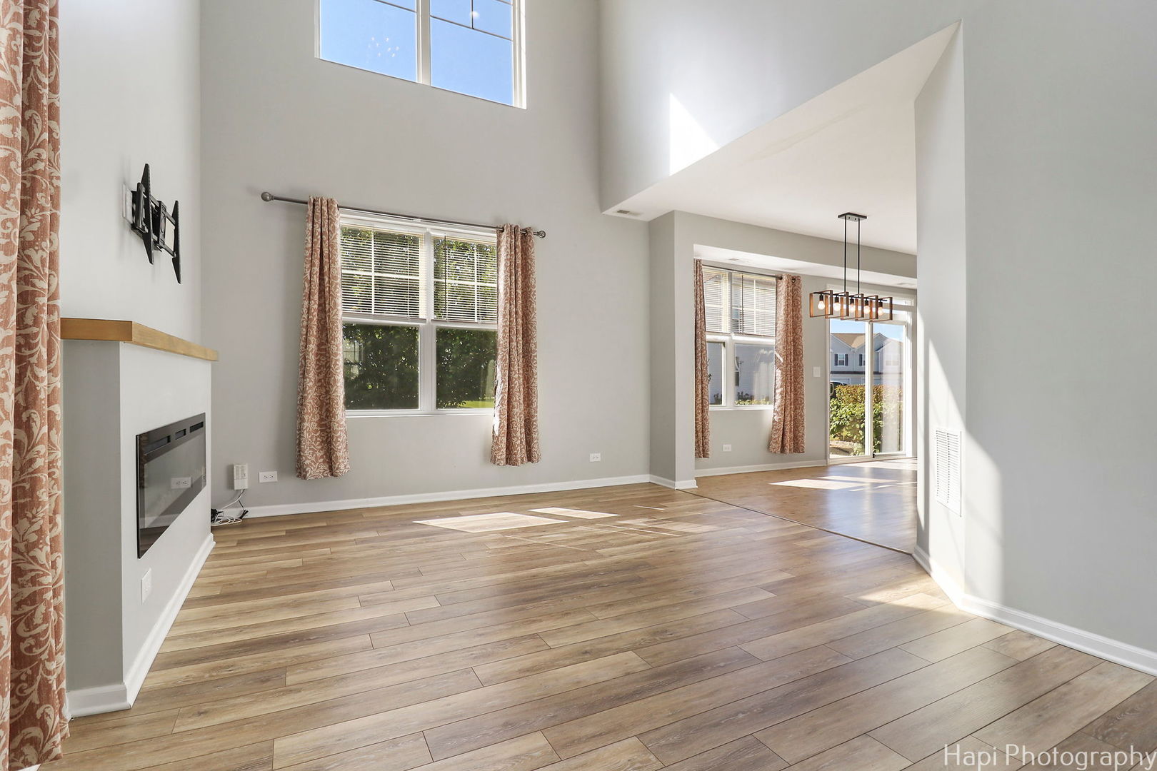 672 Anchorage Court Pingree Grove, IL 60140 - Photo 4 of 31 a view of an empty room with wooden floor and a window