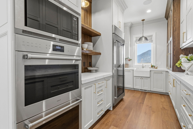 115 East Hidden Ridge Lane, Unit 42 Mapleton, UT 84664 - Photo 14 of 103 Gourmet kitchen with integrated stainless steel appliances, white cabinetry, and wood-finish flooring
