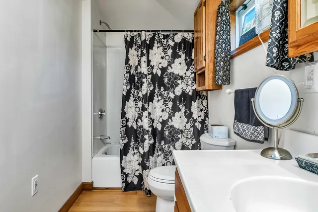 a bathroom with a sink toilet and a mirror