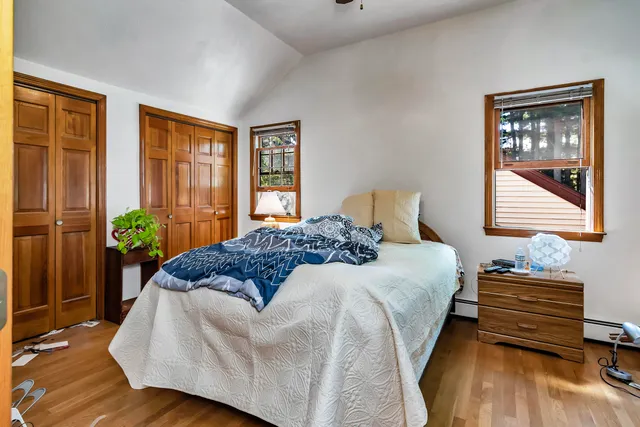 a bedroom with bed and window