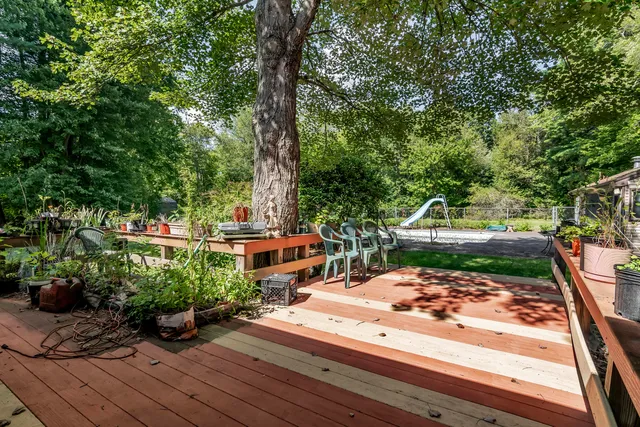 a view of a lake with a bench and trees